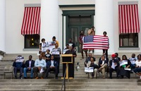 A man gives a speech during the post-march rally for Trayvon Martin on the western steps of the Old Capitol (1845) on the forty-fourth anniversary of Dr. Martin Luther King, Jr.'s assassination.