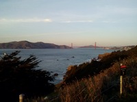 Golden Gate Bridge from a trail near Sutro Baths just before sunset.