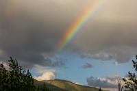 An extremely bright and vivid rainbow in the sky over Coldfoot seen from the parking lot of the Arctic Interagency Visitor Center (2004).