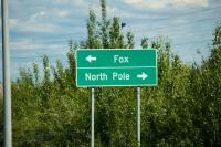 Fairbanks roadway sign for the Steese Expressway (AK 2) directing northbound traffic left toward Fox and southbound traffic right toward North Pole.