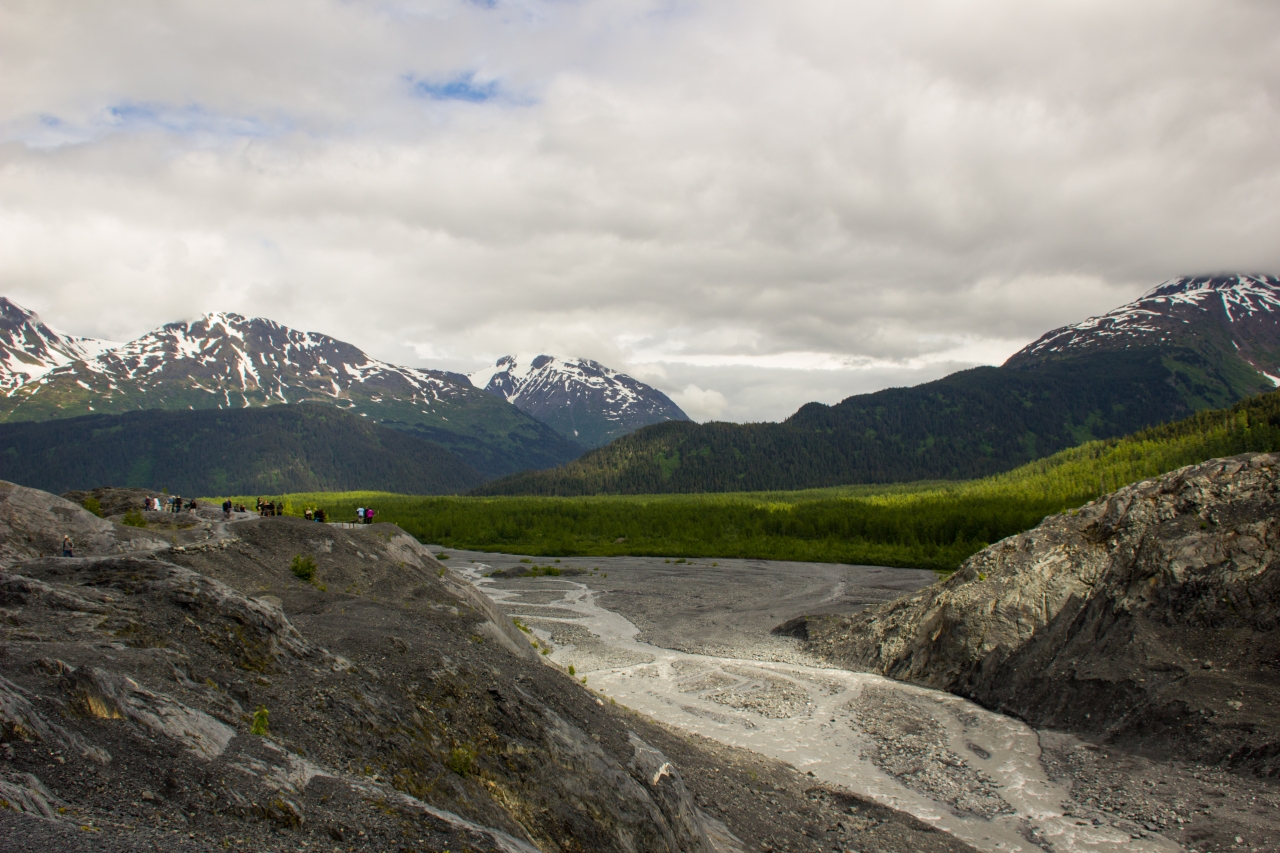 Outwash plain, forests, mountains and visitors east of Exit Glacier from the last segment of the Edge of the Glacier Trail.