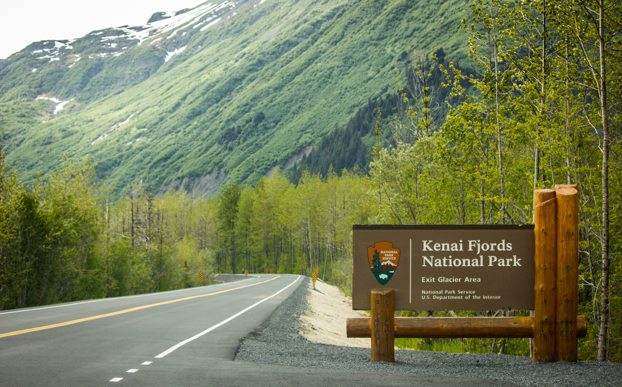 Kenai Fjords National Park entrance sign on the road to Exit Glacier.