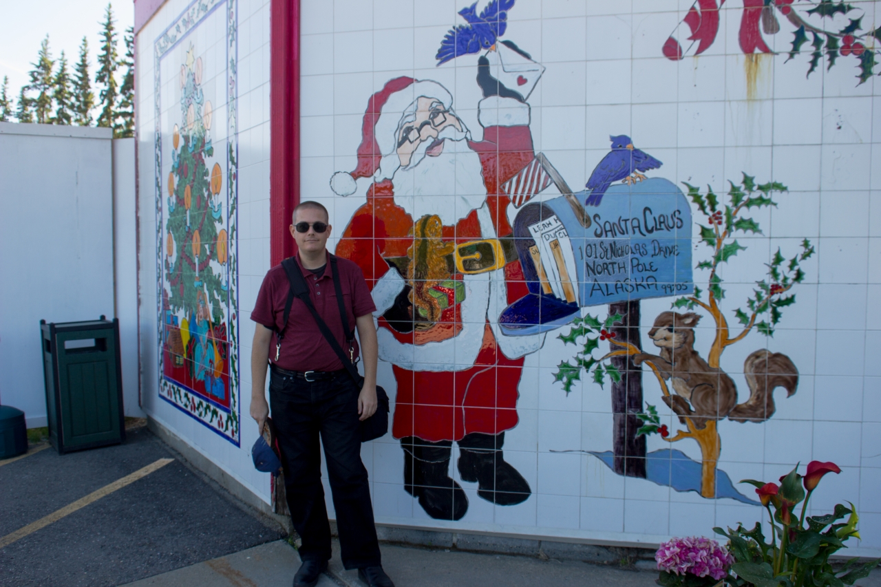 David July at the painted tile entrance to the Santa Claus House (1952).