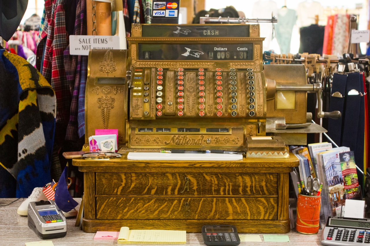 A vintage National Cash Register Company brass register (1908) with fifty-four keys and two drawers still in use at Urbach's Clothiers.