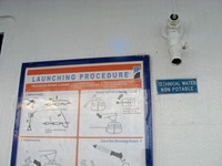 Lifeboat launching procedure poster, water spigot and 'Technical Water Non Potable' sign along the Deck 10 starboard exterior corridor on Carnival Sensation.