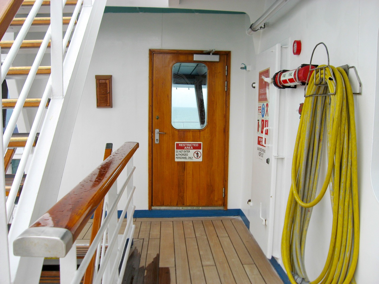 'Restricted Area Do Not Enter Authorized Personnel Only' sign on the port door to the bridge, seen from the Deck 10 exterior corridor on Carnival Sensation.