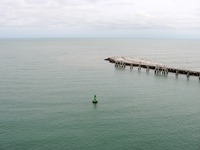 Green channel marker and the end of the Malcolm E. McLouth Fishing Pier at Jetty Park, seen from the Deck 11 forward lookout above the bridge on Carnival Sensation.