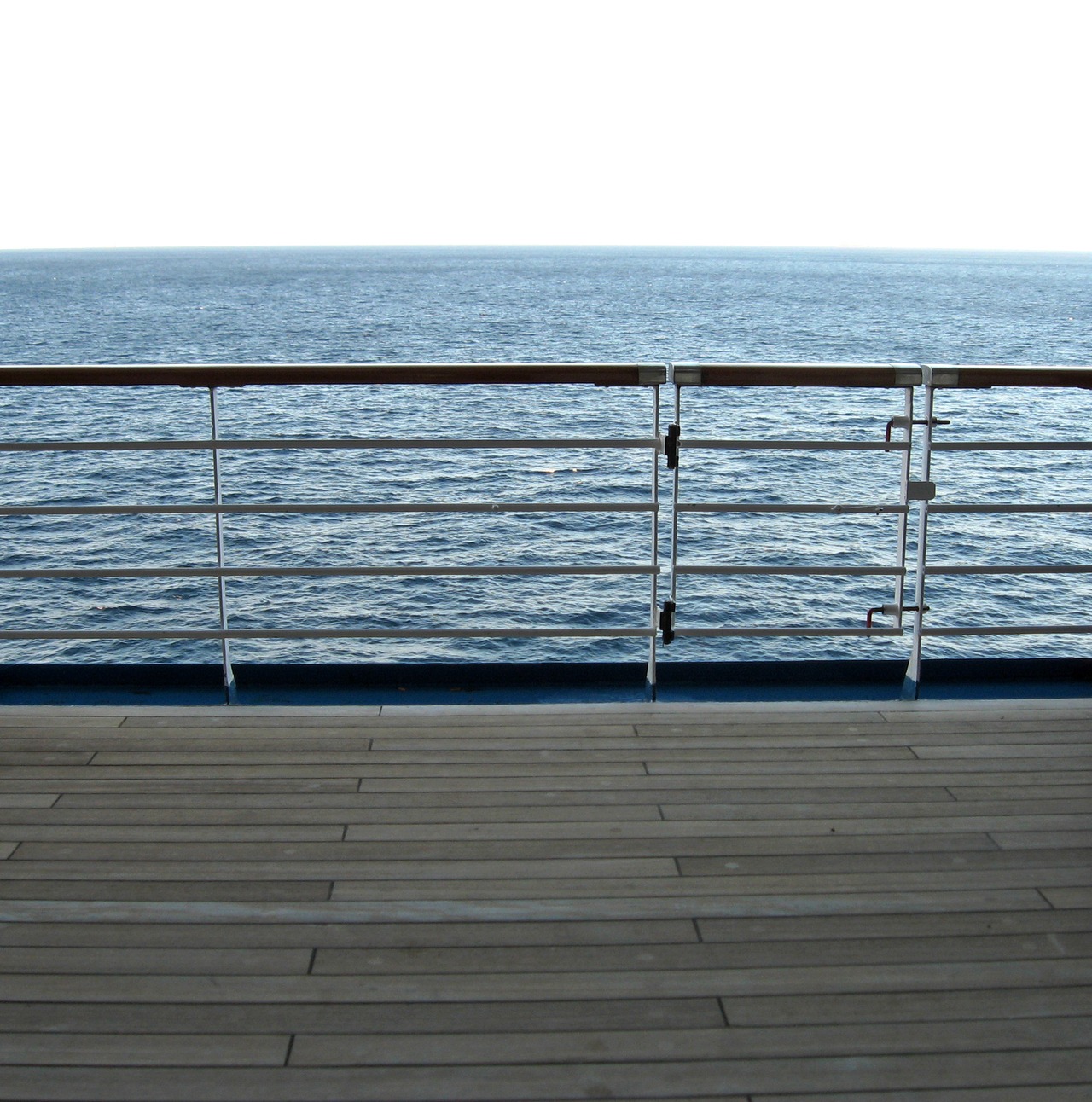 The Atlantic Ocean and railing along the Deck 10 starboard exterior corridor on Carnival Sensation.