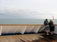 A mother and son look at the Atlantic Ocean from the starboard side of the Deck 11 forward lookout above the bridge on Carnival Sensation.
