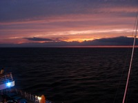 The sun sets over the Atlantic Ocean, seen from the Deck 11 port aft lookout on Carnival Sensation.