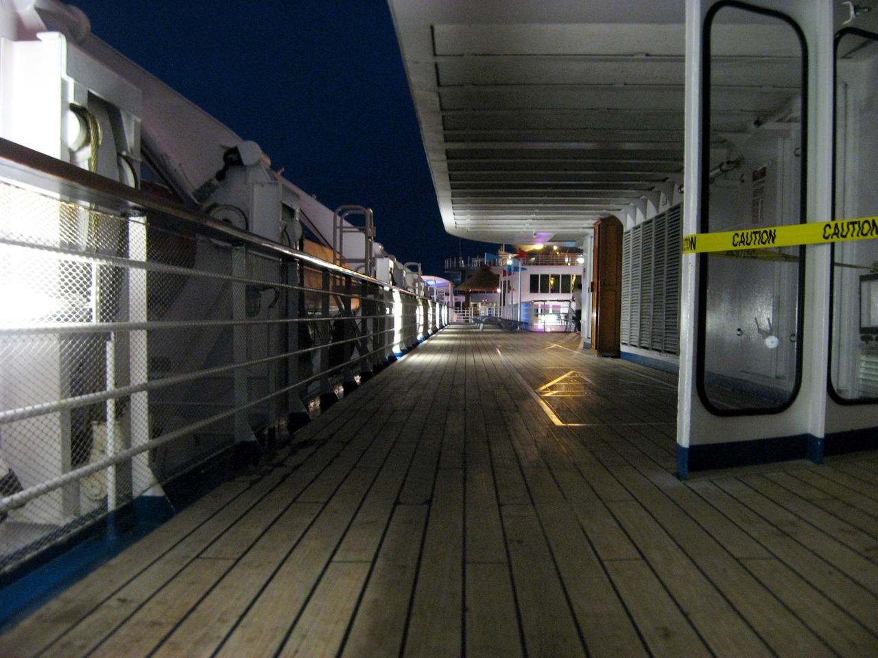 Looking forward on the Deck 11 port exterior corridor under the ship's smokestack on Carnival Sensation.