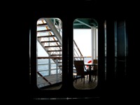 View of the starboard deck and Atlantic Ocean through glass doors, seen from a booth in the Seaview Bar & Grill on Carnival Sensation.