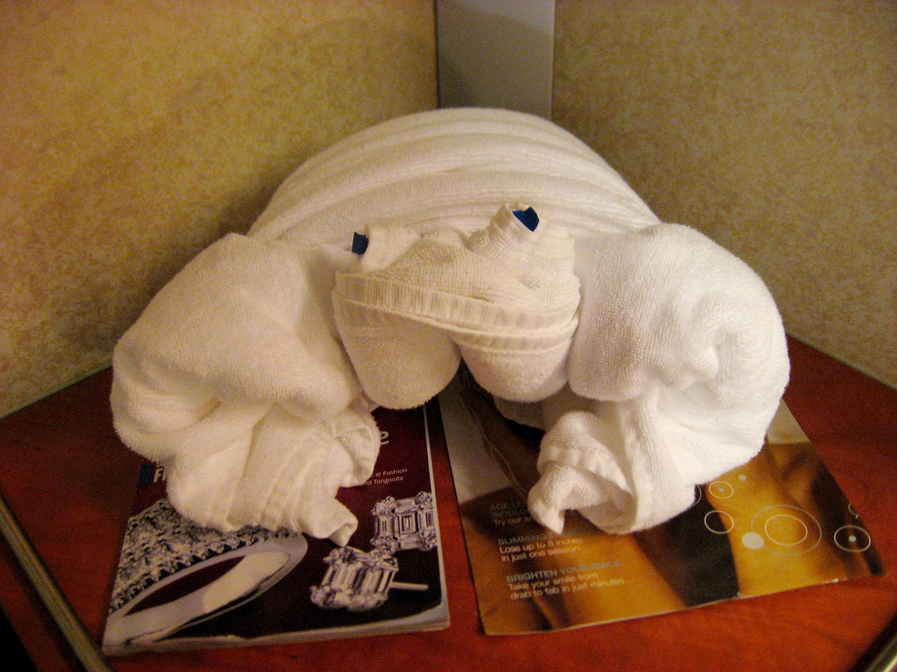 Crab cabin turndown towel animal (2/3) on the bed, seen in Cabin E-220, Deck 7 port aft on Carnival Sensation.