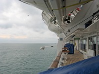 Atlantic Ocean from under stored lifeboats and the Deck 10 starboard exterior corridor on Carnival Sensation.