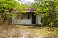 A small, single room building at the side of the road used as a school by children in rural Quintana Roo, Mexico.