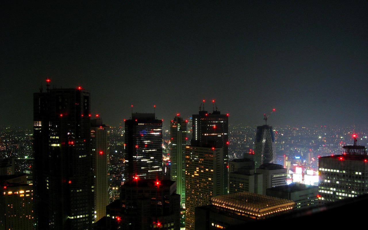Tokyo Metropolitan Government Building (1991) and the red lights of Shinjuku from a NE window at the New York Bar on 52F of Shinjuku Park Tower (1994).