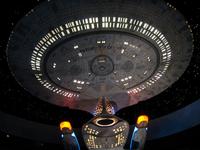 Large illuminated model of the starship USS Enterprise NCC-1701-D hanging from the ceiling at Star Trek: The Experience.