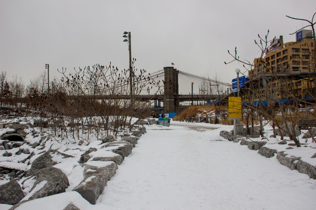 The bike path and Brooklyn Bridge (1883) eastern tower from the Brooklyn Bridge Park (2010) Pier 1 boat ramp.