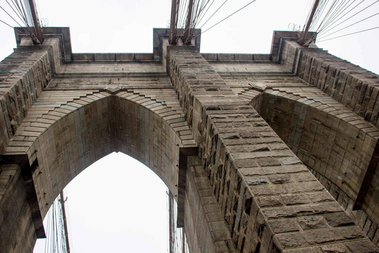 Four main cables leading up to the eastern side of the eastern tower of the Brooklyn Bridge (1883) from the pedestrian and cyclist promenade.