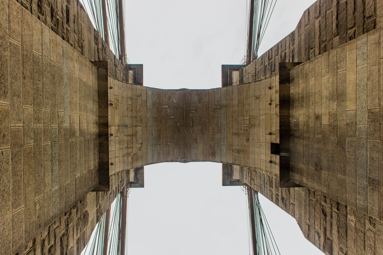 Looking up under the eastern tower of the Brooklyn Bridge (1883) from the pedestrian and cyclist promenade.