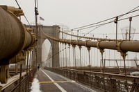 Three of the four main cables leading up to the eastern side of the eastern tower of the Brooklyn Bridge (1883) from the pedestrian and cyclist promenade.