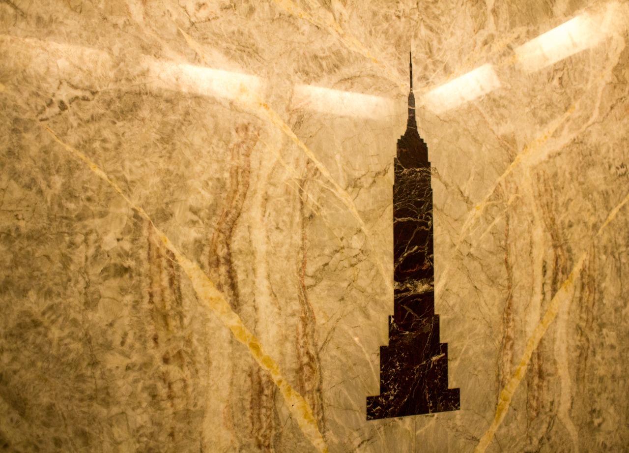 A silhouette of the building set in a marble wall in the 80F visitors center of the Empire State Building (1931).