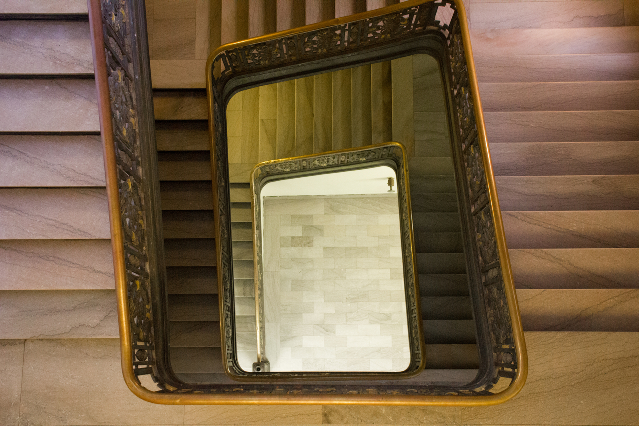 Looking down the southern stairway from the third level of the College of Fine Arts Building (1916) at Carnegie Mellon University.