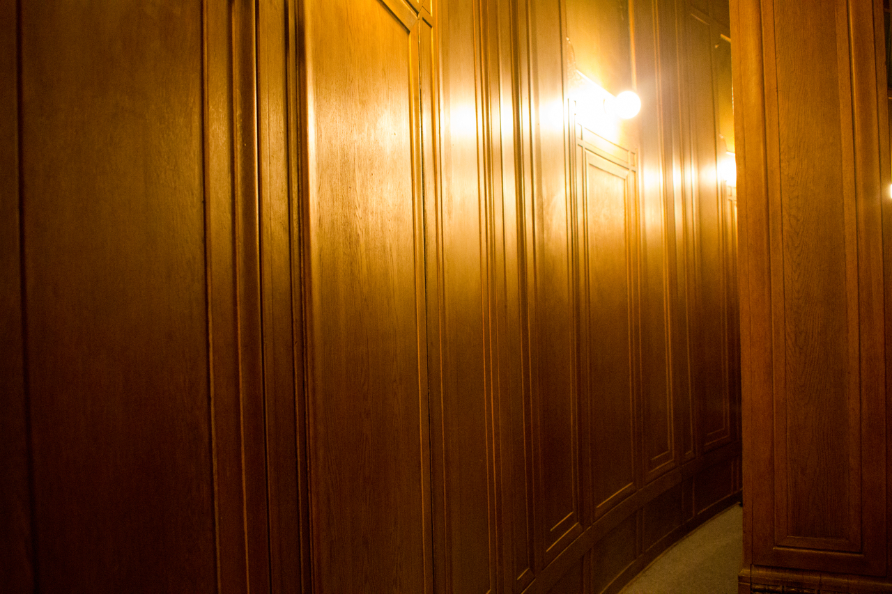 The curved and wood-paneled back wall of the Kresge Theatre in the College of Fine Arts Building (1916) at Carnegie Mellon University.