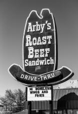 An original Arbys Restaurant ten-gallon cowboy hat sign (1973) with neon and light bulbs at Store 619 in Meadville, Pennsylvania — photograph by David July