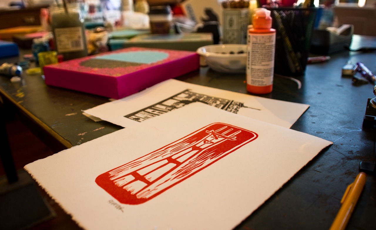 Among artwork in progress by Annie Galvin, my hand pulled linocut print from a painted linoleum sheet carved with Sutro Tower artwork by Eric Rewitzer.