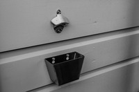 Bottle opener and cap receptacle mounted in the spacious backyard of 3 Fish Studios.