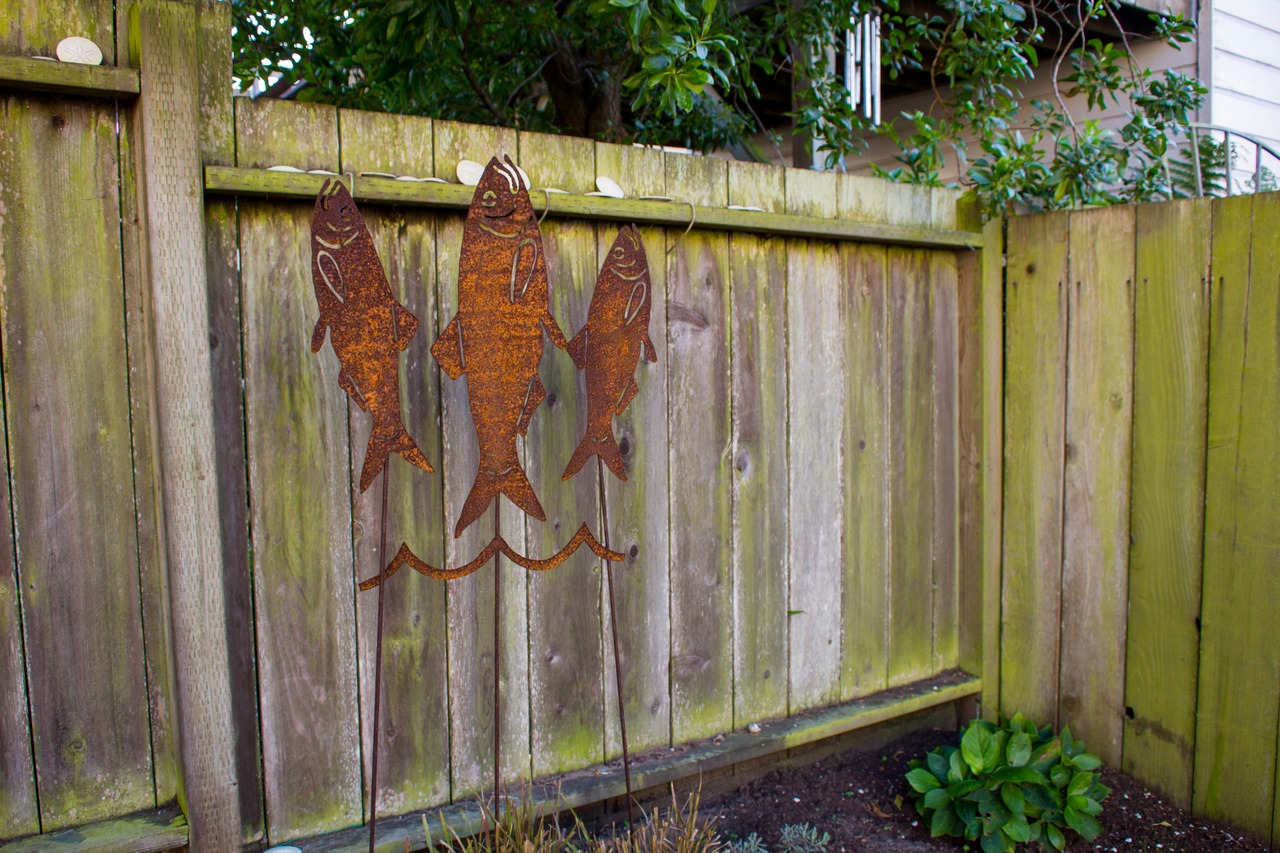 Eric Rewitzer's and Annie Galvin's logo in metal in the spacious backyard of 3 Fish Studios.