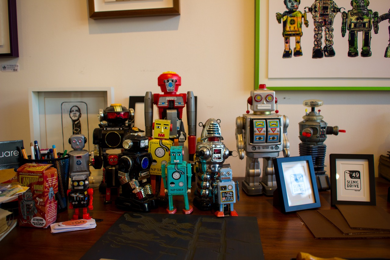 Toy robots on a shelf in 3 Fish Studios, some of the models used for artwork by Eric Rewitzer.