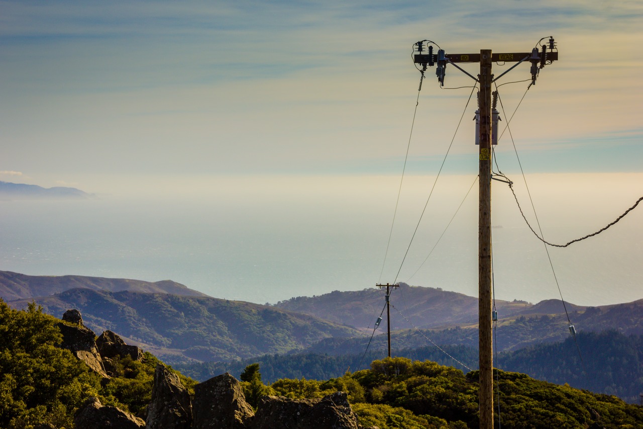Power lines to the Mount Tamalpais East Peak fire lookout tower and the Pacific Ocean beyond from atop the 2,571 feet summit at the end of the Plank Walk Trail in Mount Tamalpais State Park.