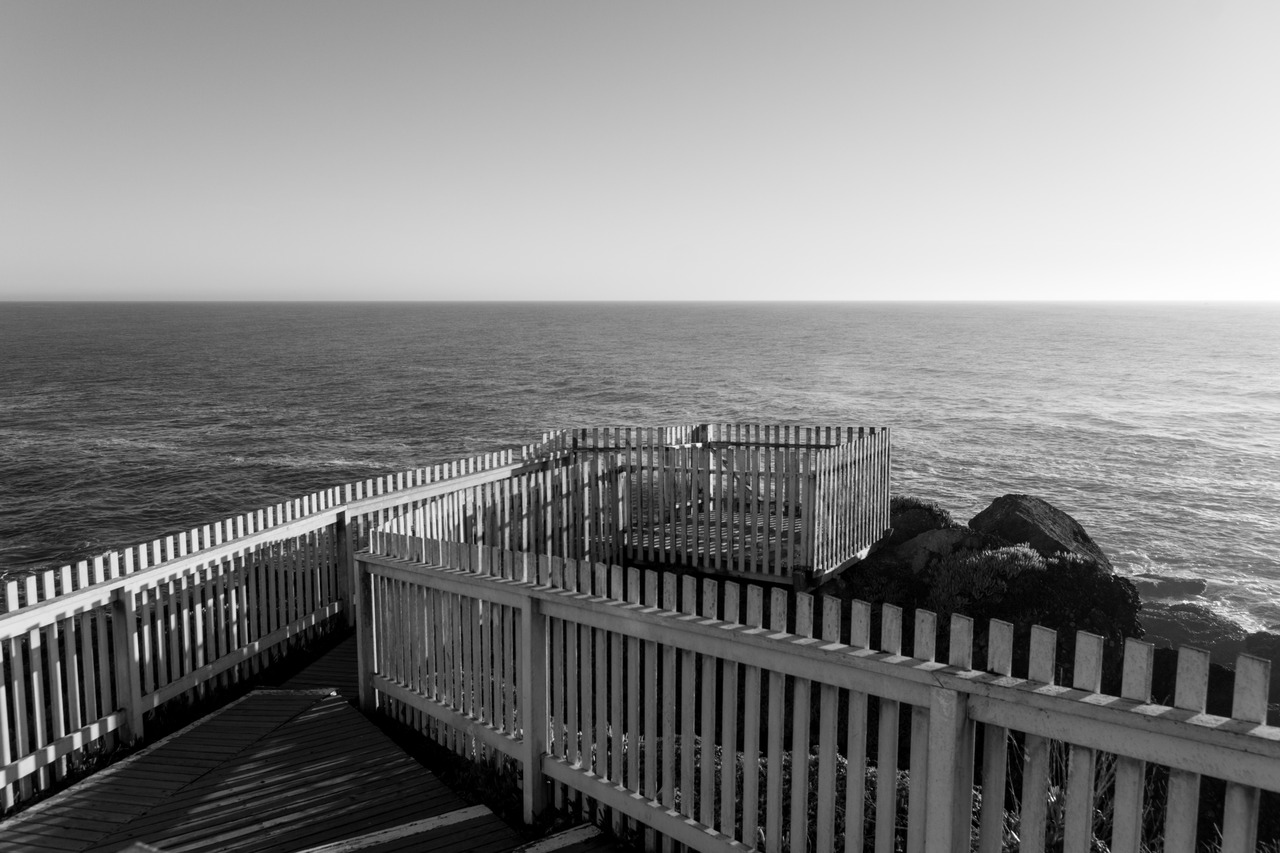 A small wooden platform extending south onto the edge of the rocky promontory upon which the Pigeon Point Lighthouse (1871) is built.