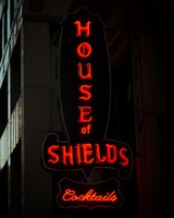 The red neon sign of The House of Shields saloon, which also says 'cocktails' instead of 'live music' now.