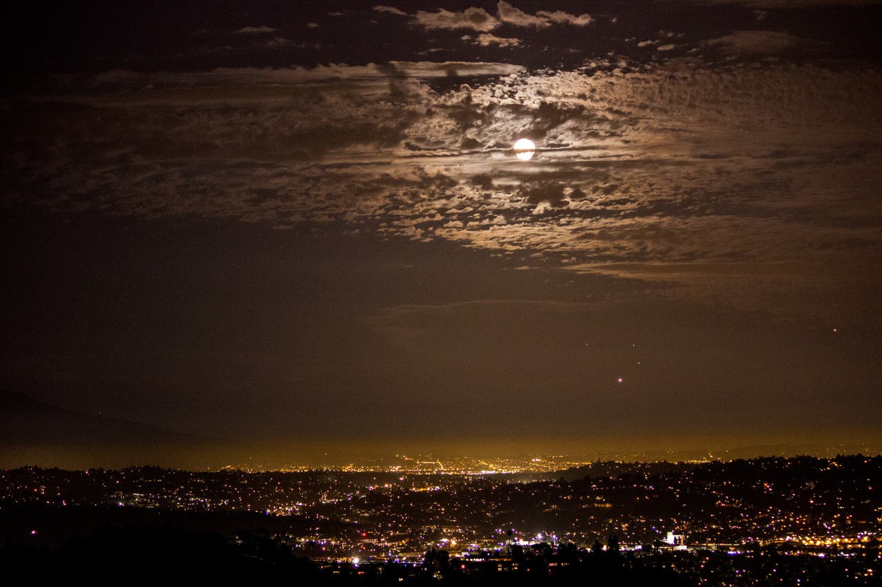 Moon, clouds and airplanes in the sky over eastern Los Angeles County, Pomona and San Bernardino from the Griffith Observatory (1935).