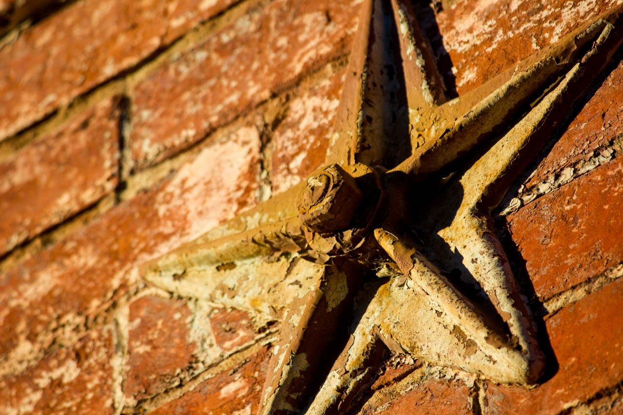A cast iron star-shaped anchor plate on the semi-detached brick house at 311 Queen Street (1880) in Old Town Alexandria.