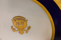 A plate from Lenox's 'Wilson Service' White House china set (1918) designed by Frank Holmes and bearing in raised gold the presidential coat of arms on display in the first floor kitchen in the Woodrow Wilson House (1915).