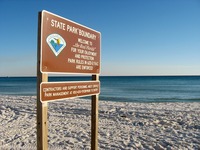 Henderson Beach 'State Park Boundary' sign on the beach near Silver Shells Resort.