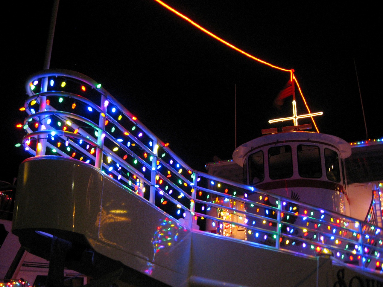 Colorful lights aboard Robbins & Sons 'Southern Star' (2001) at HarborWalk Marina next to The Lucky Snapper Grill & Bar.