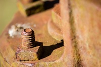 Bolt and washer at the base of the hand water pump over a trough for the mule lot at Dudley Farm Historic State Park.