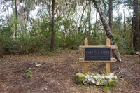 A sign 'in memory of Martin J. Roess a lover of nature who contributed liberally to the establishment of Gold Head Branch State Park' at the head of the ravine stairway at Mike Roess Gold Head Branch State Park.