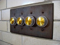 Four dimmer knobs in the Stable Complex (1928) Carriage Room at Pebble Hill Plantation.