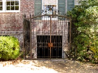 Metal gate next to the west wing guest entrance of the main house (1936) at Pebble Hill Plantation.