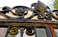 Top of the metal gate next to the west wing guest entrance of the main house (1936) at Pebble Hill Plantation.