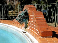 Animal head fountain at the north end of the swimming pool (1920) at Pebble Hill Plantation.