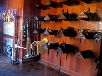 Trophies, polo mallets and saddle racks in the Tack Room of the Stable Complex (1928) at Pebble Hill Plantation.