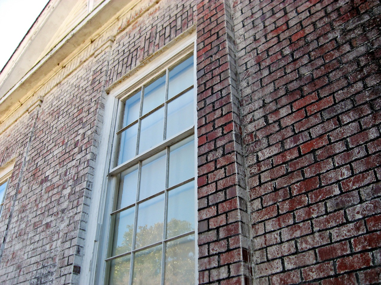 Window and brick exterior wall of the main house's east wing (1914) at Pebble Hill Plantation.