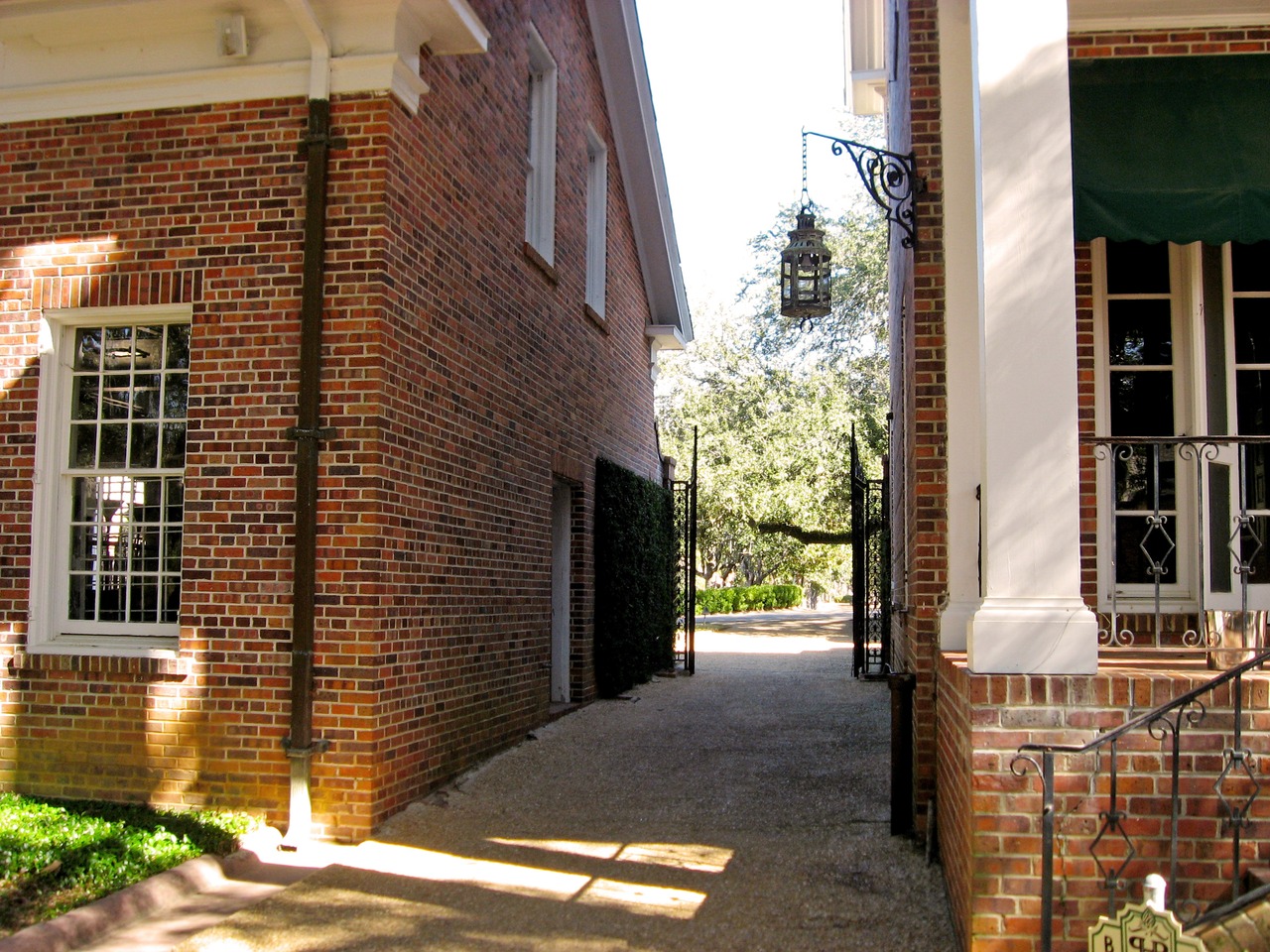 Walkway from the Stable Complex (1928) courtyard next to the Garden Cottage at Pebble Hill Plantation.